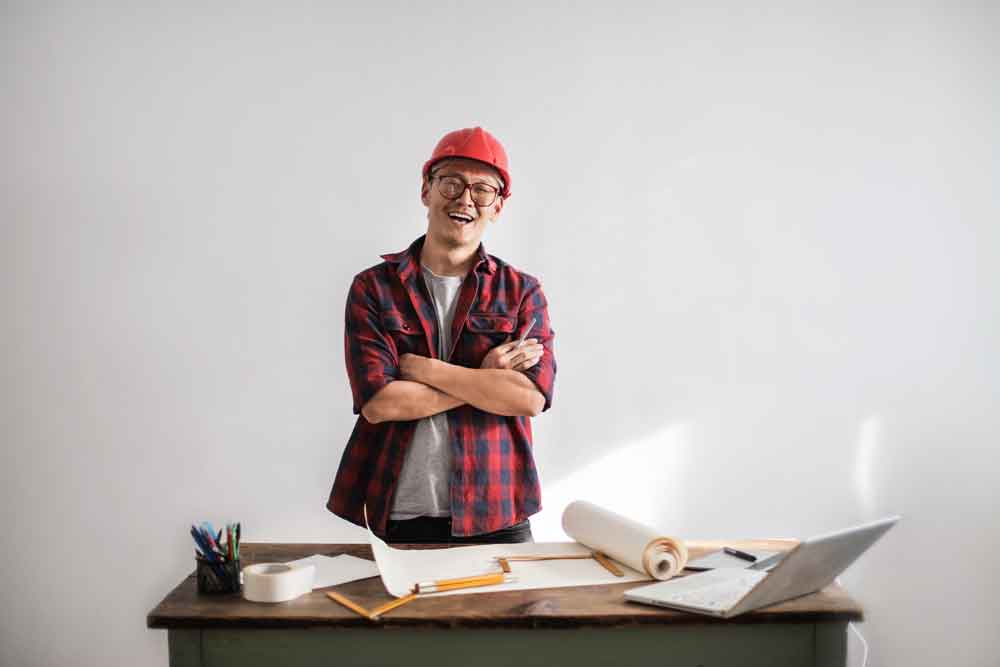 happy construction worker at desk
