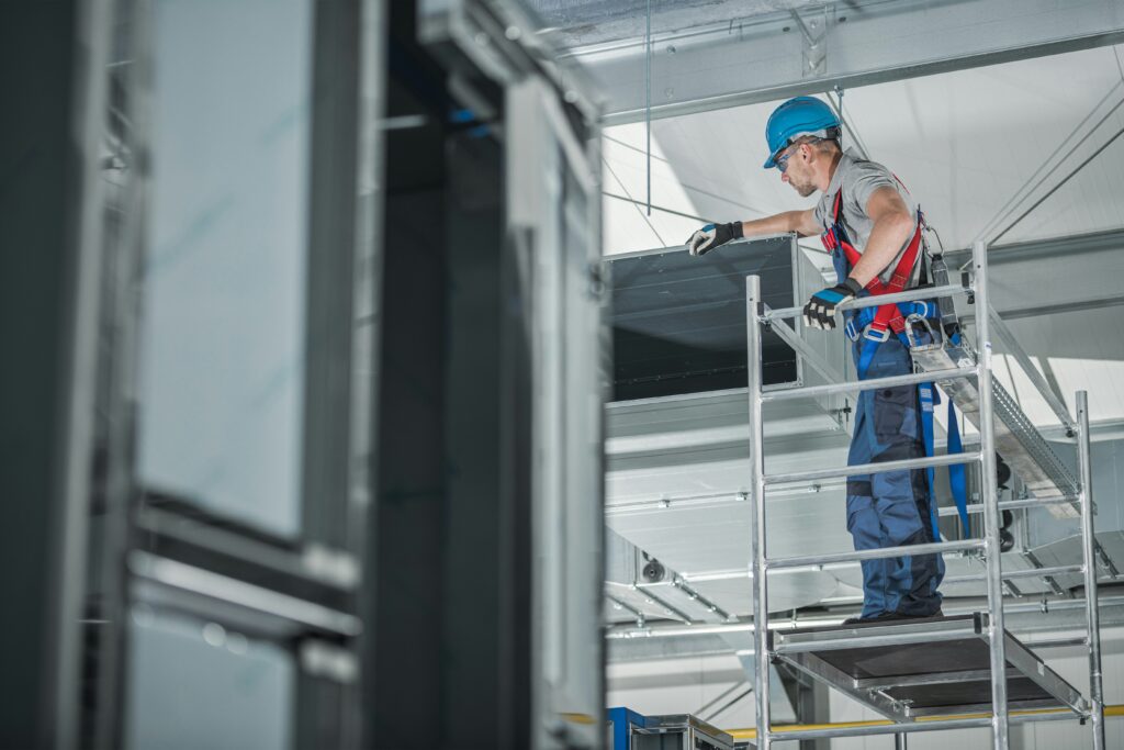 HVAC business owner installing system on ladder